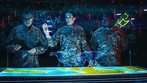 Three military officers in camouflage uniforms analyze a digital world map on a futuristic control table.