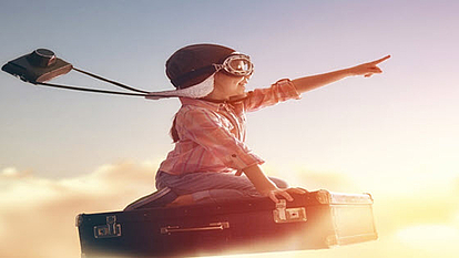 Child in aviator goggles pointing forward, symbolizing innovation and future-proof technology in CHIRplus_TC software.