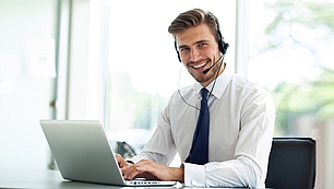 Web Seminars for Spectrum Training Trainer with headset and laptop representing online seminars and digital training.