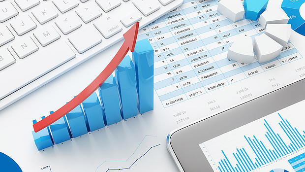 Network Optimization & Expansion – Enhancing Performance & Efficiency 3D bar chart with an upward red arrow on financial documents, symbolizing LS telcom’s network optimization and expansion services for improved coverage, cost efficiency, and QoS.