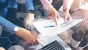 Technology Consulting for Spectrum Projects Hands review technical plans and data, representing consulting for efficient spectrum and network projects.